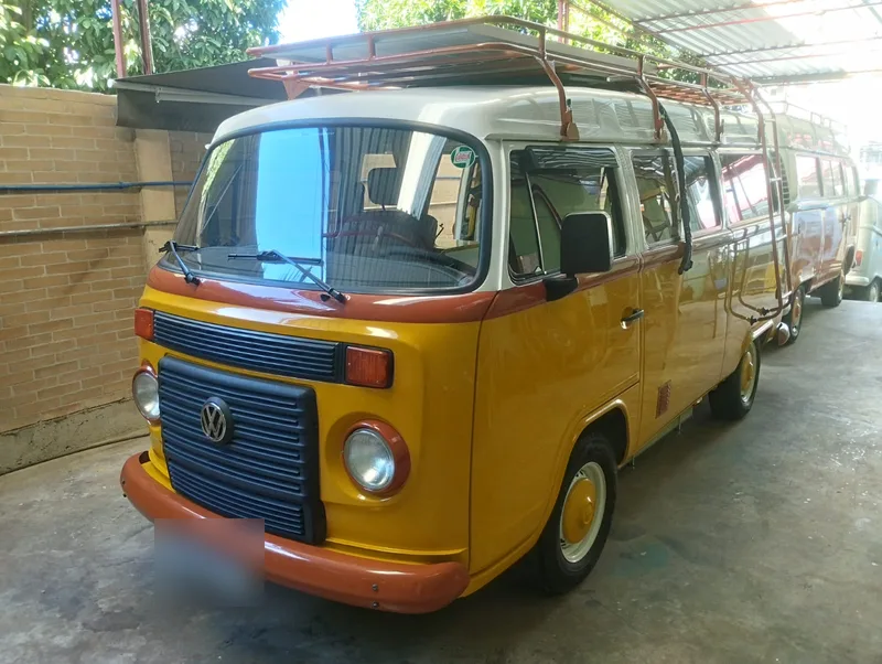 Kombi TR2 montada pela Camper RJ, amarela e branca, com bagageiro de teto e escada